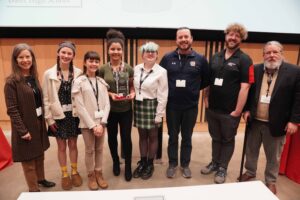 Photo of Walnut Hills team with judges after winning