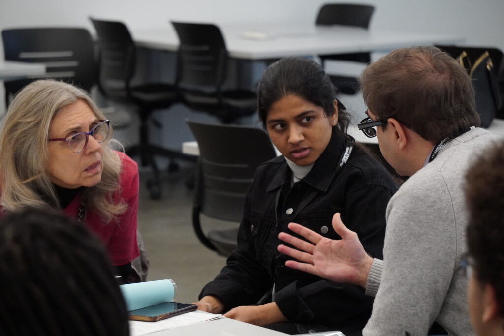 Judges deliberating prior to the Q&A portion of a round