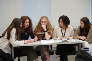 Picture of St. Ursula team deliberating over case question.