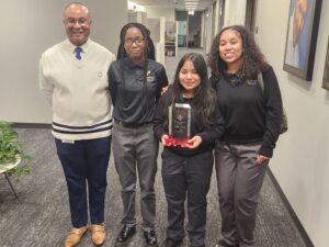 Image of DePaul Cristo Rey accepting trophy